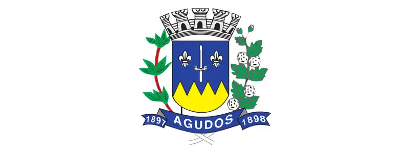 Brasão oficial do município de Agudos, com escudo azul e amarelo, coroado na parte superior, ladeado por ramos verdes e fita inferior com o nome Agudos e as datas 1897 e 1898.