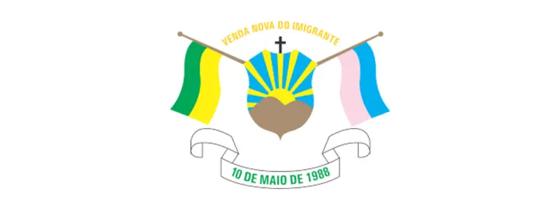 Brasão de Venda Nova do Imigrante com escudo central, sol nascente, cruz no topo, bandeiras laterais verde e amarela e azul e branca, e faixa com a data 10 de maio de 1988