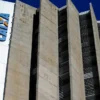 Prédio da Caixa Econômica Federal com fachada de concreto e o logotipo da instituição em destaque, visto de baixo contra o céu azul. Foto: Divulgação/Marcelo Camargo - Agência Brasil