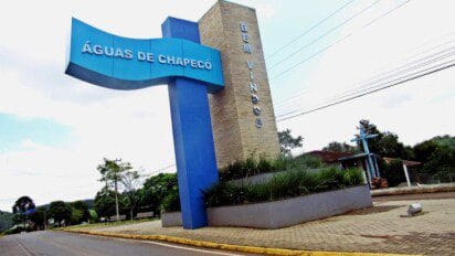 Portal de entrada de Águas de Chapecó com estrutura azul e letreiro “BEM VINDOS” ao fundo, rodeado por vegetação e área urbana. Foto: Divulgação/Prefeitura de Águas de Chapecó-SC