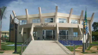 Fachada do palácio da prefeitura com bandeiras e chafariz, sede do concurso Cristalina GO