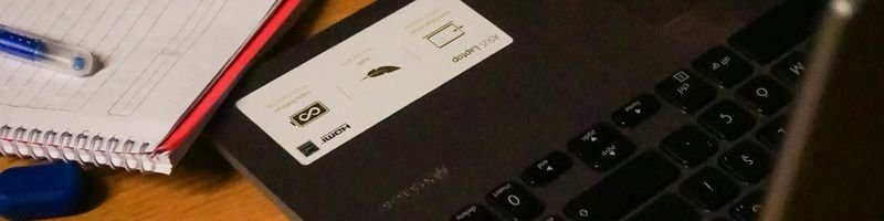 Cerquilho/SP abre concurso com 141 vagas de até R$ 17,7 mil 2 Caderno com caneta azul ao lado de um notebook parcialmente fechado sobre uma mesa de madeira.