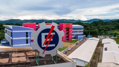 Vista do campus da UNIFEI com prédio colorido ao fundo e logotipo da universidade em destaque. Foto: Divulgação/UNIFEI