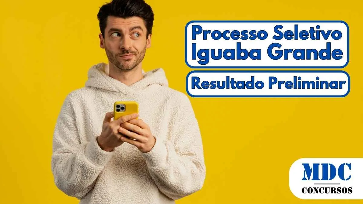 Iguaba Grande (RJ) Divulga Resultado Preliminar de Processo Seletivo 2025 1 Homem jovem de pele clara e cabelos escuros segurando um smartphone amarelo e olhando para o lado com expressão curiosa, vestindo um moletom branco de pelúcia, em frente a um fundo amarelo sólido - Iguaba Grande (RJ) Divulga Resultado Preliminar de Processo Seletivo 2025