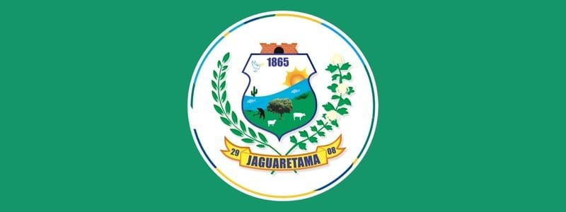 Jaguaretama CE abre seleção com 51 vagas de até R$ 2,5 mil 1 Brasão do município de Jaguaretama sobre fundo verde, com elementos como sol, árvore, animais e ramos, além do nome Jaguaretama e a data 1865.
