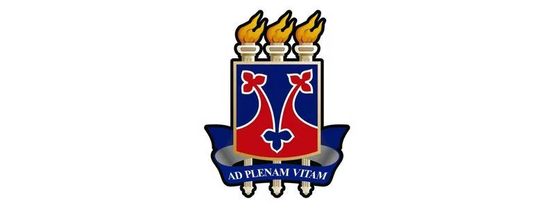 Vestibular 2026 UESB abre 998 vagas em Cursos de Graduação 1 Brasão da UESB com três tochas acesas no topo, escudo vermelho e azul ao centro e faixa azul com a inscrição "Ad Plenam Vitam".