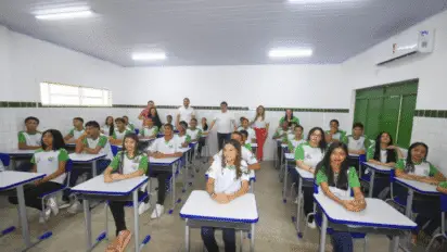 Alunos uniformizados sentados em carteiras de uma sala de aula, com professores e gestores em pé ao fundo. Foto: Divulgação/Governo do Estado do Piauí