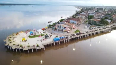 Processos Seletivos 8 Vista aérea da orla de Marabá com área urbanizada à beira do rio, tendas montadas, pessoas circulando e casas ao fundo. Foto: Divulgação/Prefeitura de Marabá-PA