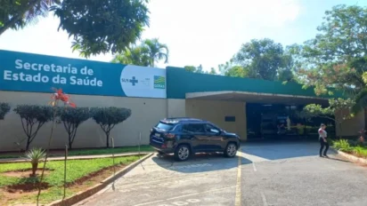 Fachada da Secretaria de Estado da Saúde de Goiás com letreiro azul e branco, entrada coberta, vegetação ao redor e um carro preto estacionado no pátio. Foto: Divulgação/SES-GO