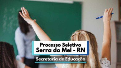 Imagem de uma sala de aula com uma professora ao fundo, em frente a um quadro verde, e duas alunas de costas com as mãos levantadas, demonstrando participação ativa. Em destaque, um banner com os dizeres "Processo Seletivo Serra do Mel - RN" e "Secretaria de Educação", indicando a abertura de seleção pública na área da educação no município de Serra do Mel, no estado do Rio Grande do Norte.