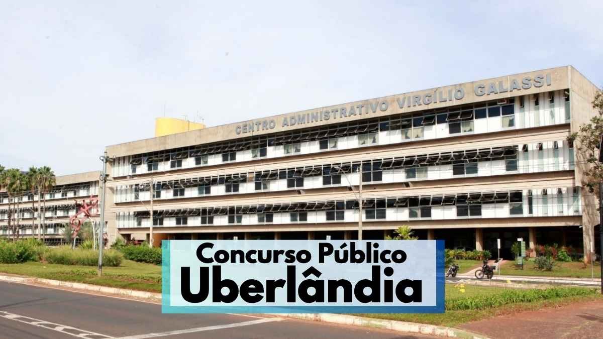 Uberlândia abre concurso com 172 vagas de até R$ 10,5 mil 1 A imagem mostra a fachada do Centro Administrativo Virgílio Galassi, sede da Prefeitura de Uberlândia, Minas Gerais. O prédio é amplo, com vários andares, janelas espelhadas e estrutura de concreto. Em primeiro plano, há uma avenida asfaltada e áreas verdes com plantas ornamentais. Na parte inferior da imagem, há uma faixa com os dizeres "Concurso Público Uberlândia" em destaque.